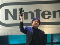 Iwata proudly shows off the Revolution.